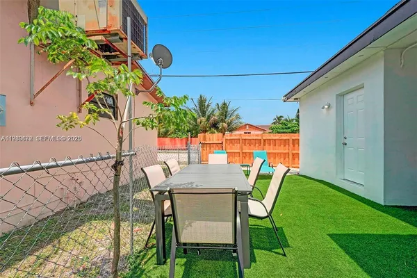 a view of a chairs and table in patio