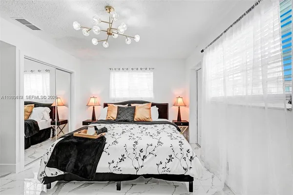 a bedroom with a bed and window