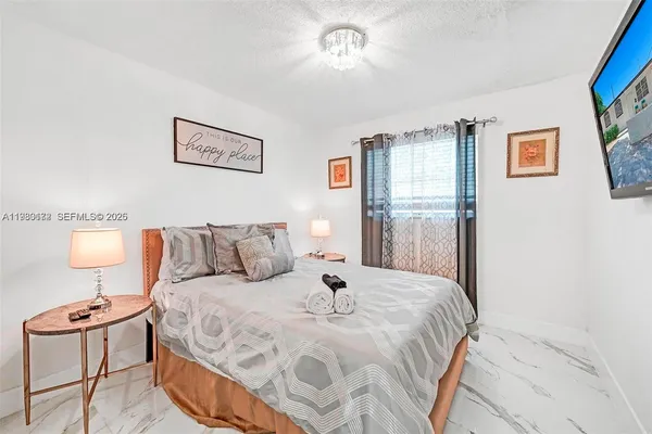 a large white bed in a white room