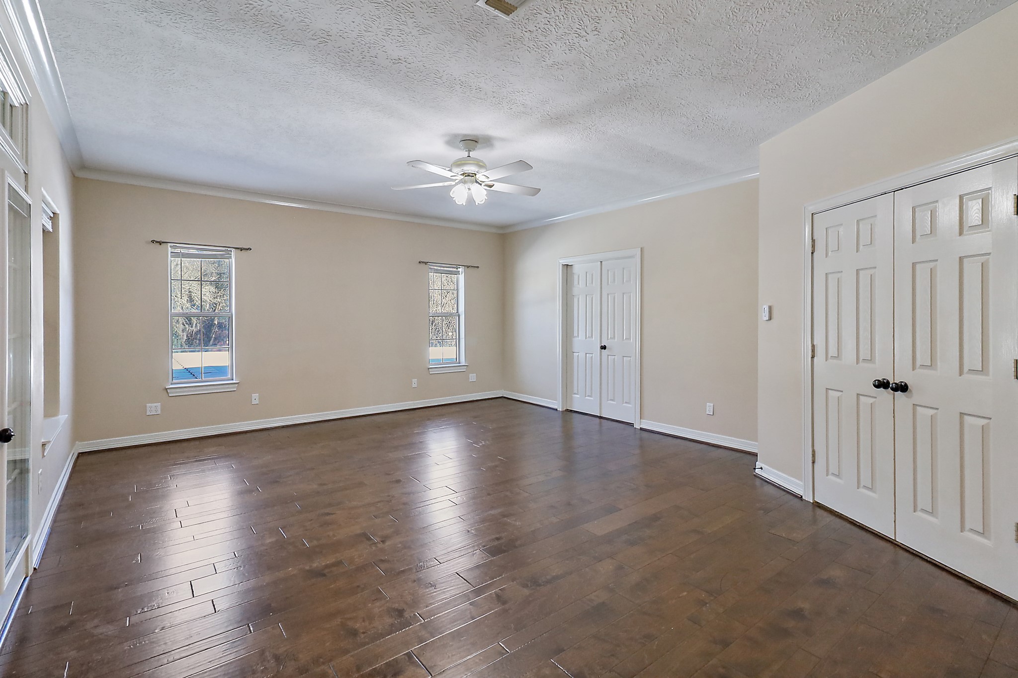 1306 Spring Branch Drive Baytown, TX 77523 - Photo 21 of 38 wooden floor in an empty room with a window