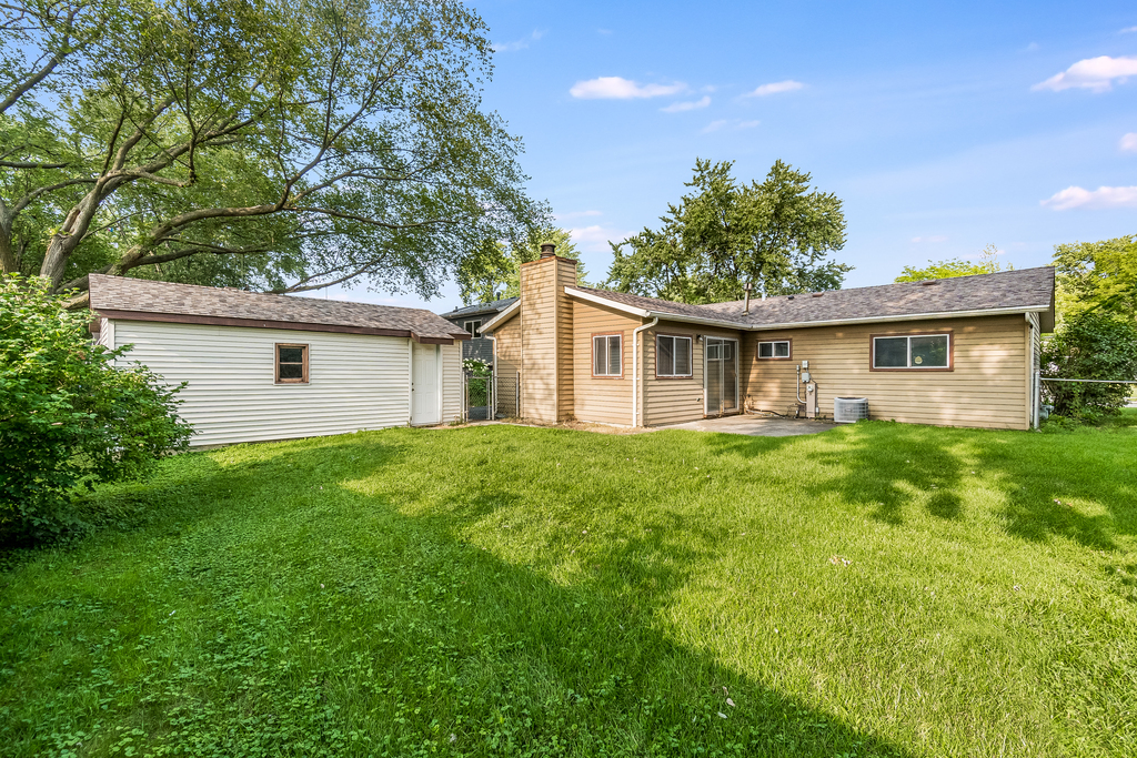 129 Springleaf Drive Bolingbrook, IL 60440 - Photo 4 of 5 a view of a house with backyard and garden