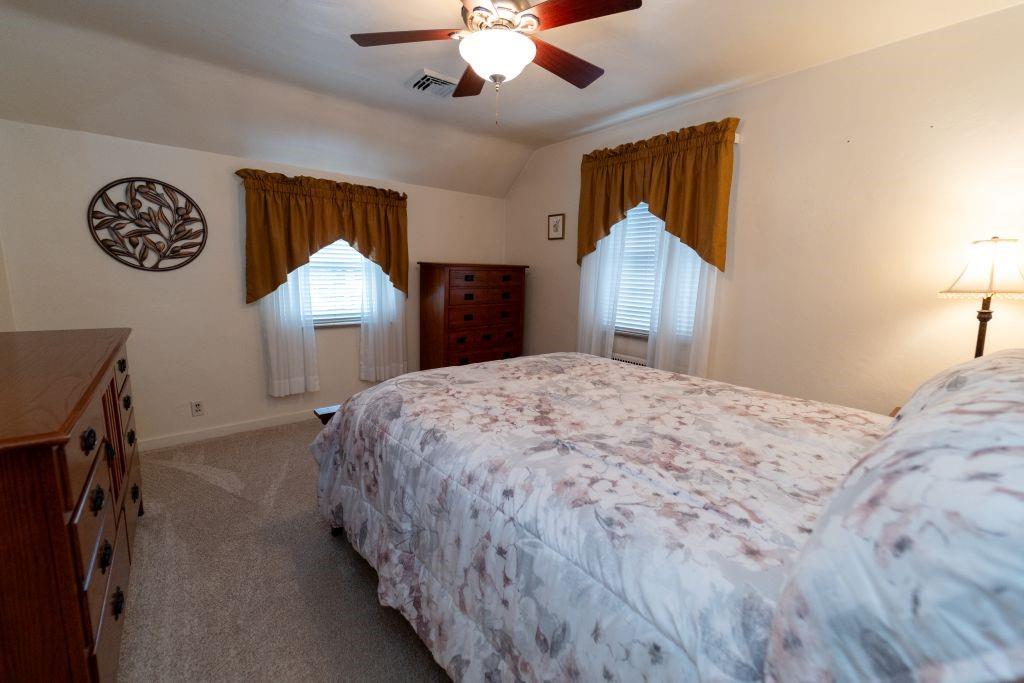 1446 Kinmount Street Pittsburgh, PA 15205 - Photo 15 of 38 a bedroom with a bed and a chandelier