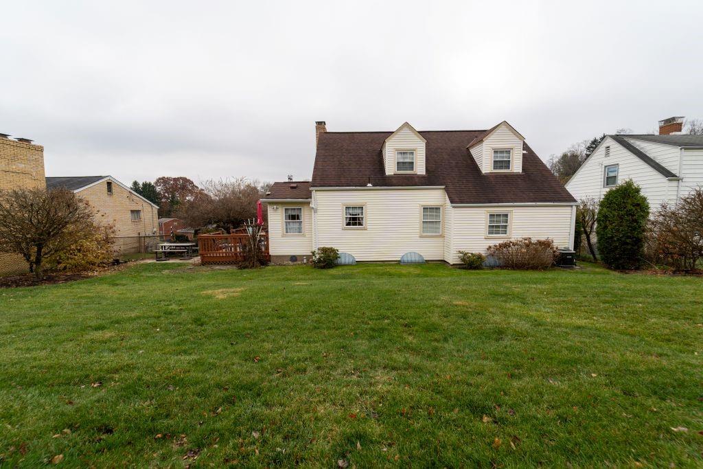 1446 Kinmount Street Pittsburgh, PA 15205 - Photo 32 of 38 a view of a white house in front of a big yard with plants and large trees