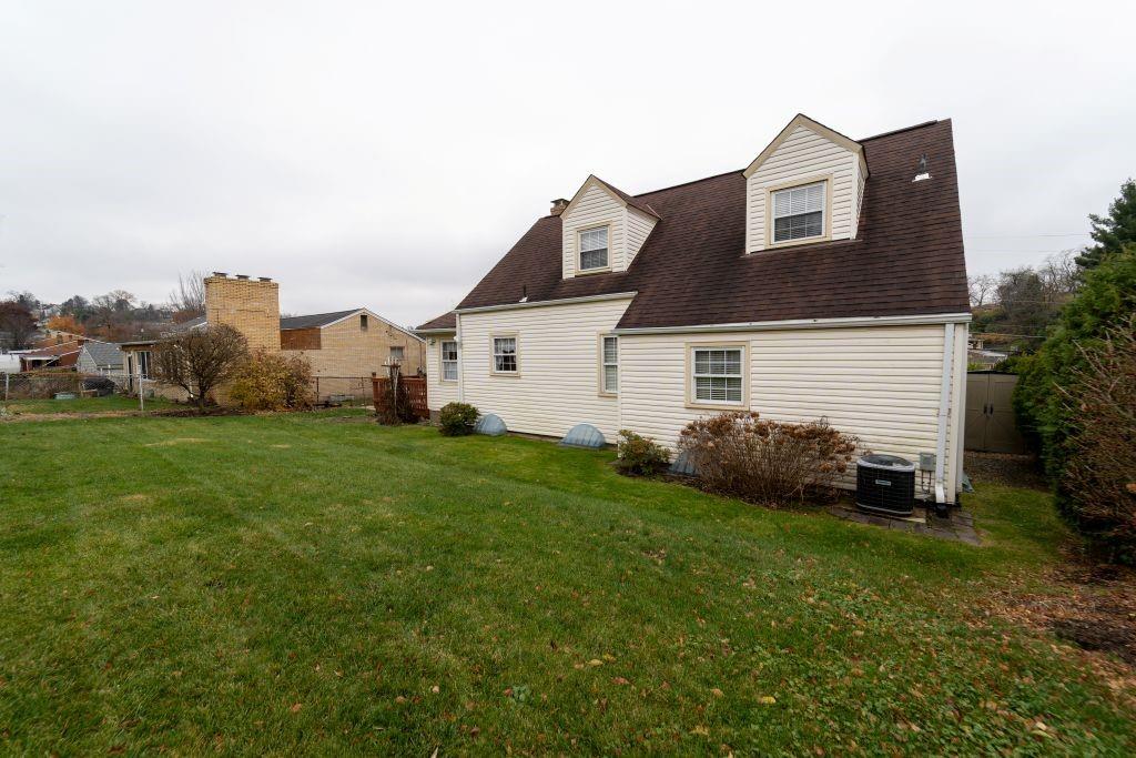 1446 Kinmount Street Pittsburgh, PA 15205 - Photo 34 of 38 a front view of a house with a yard and garage