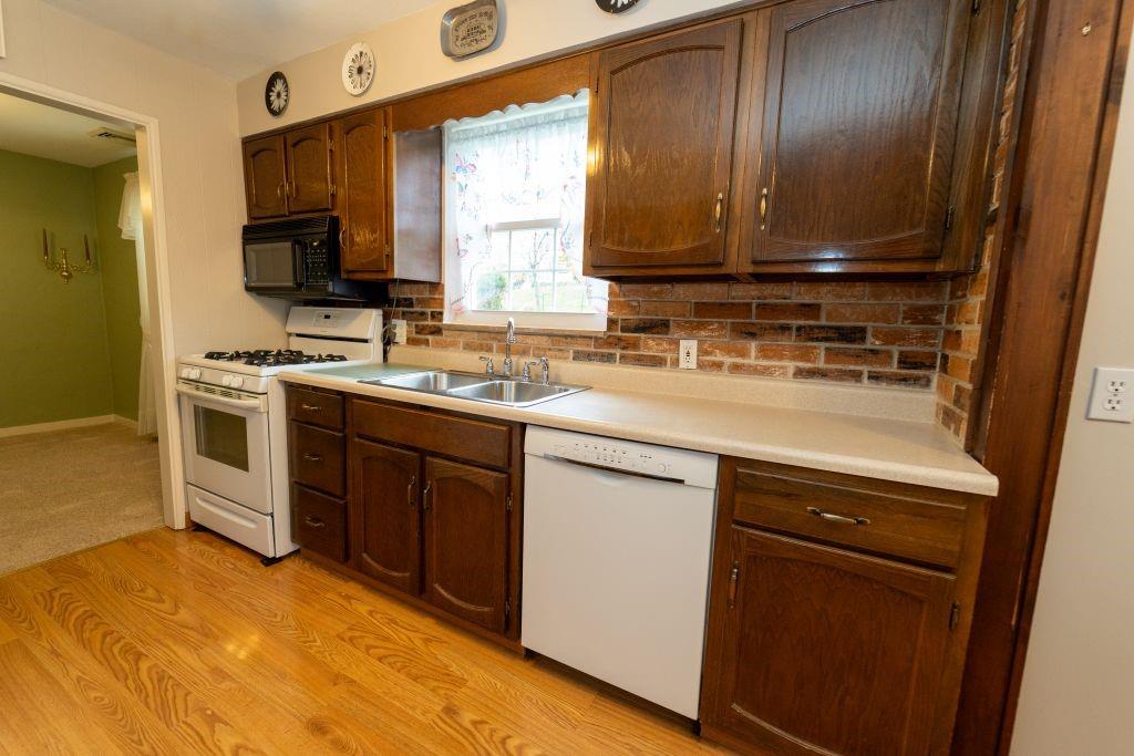 1446 Kinmount Street Pittsburgh, PA 15205 - Photo 10 of 38 a kitchen with a sink stove and microwave