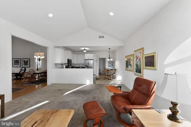 a living room with furniture and kitchen view