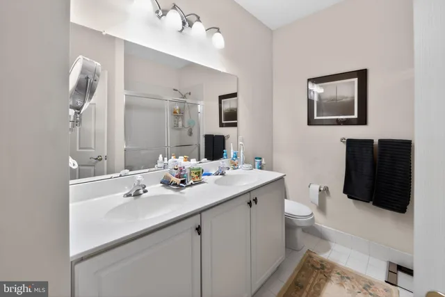 a bathroom with a sink a toilet and mirror