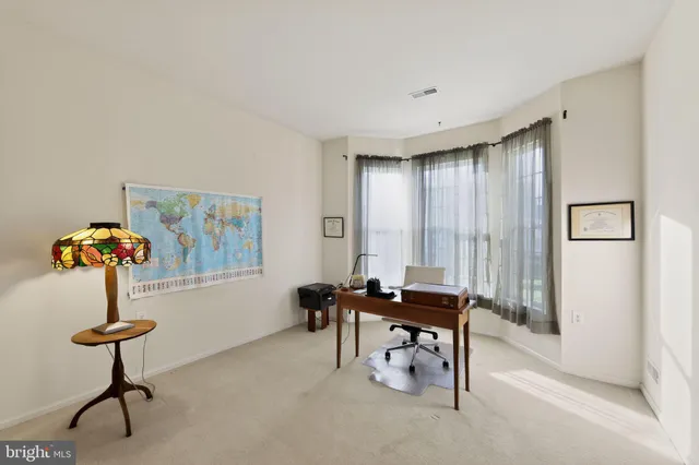 a view of a livingroom with furniture and a window