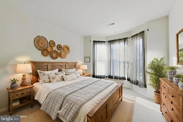 a bedroom with a bed and a painting on the wall