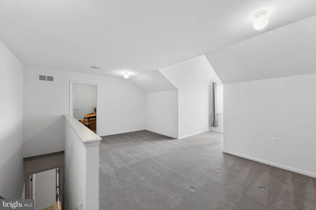 a view of an empty room with a kitchen