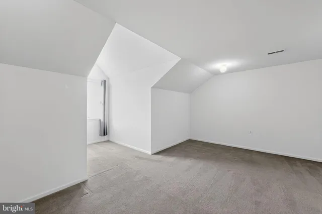 a view of an empty room with windows