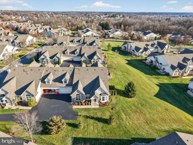 an aerial view of residential houses with outdoor space