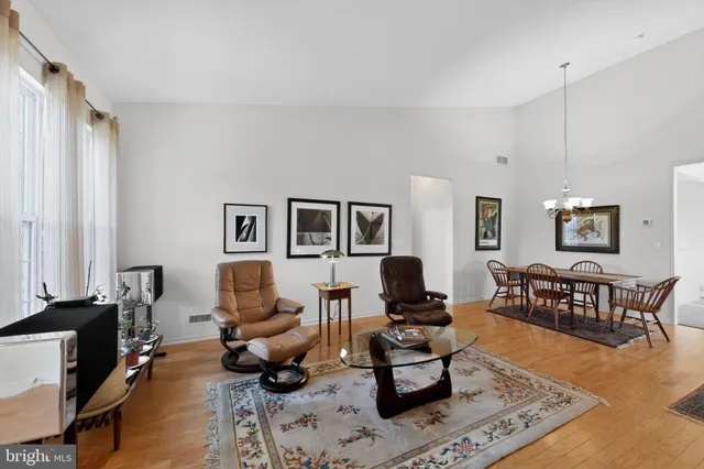 a living room with furniture a rug and a window