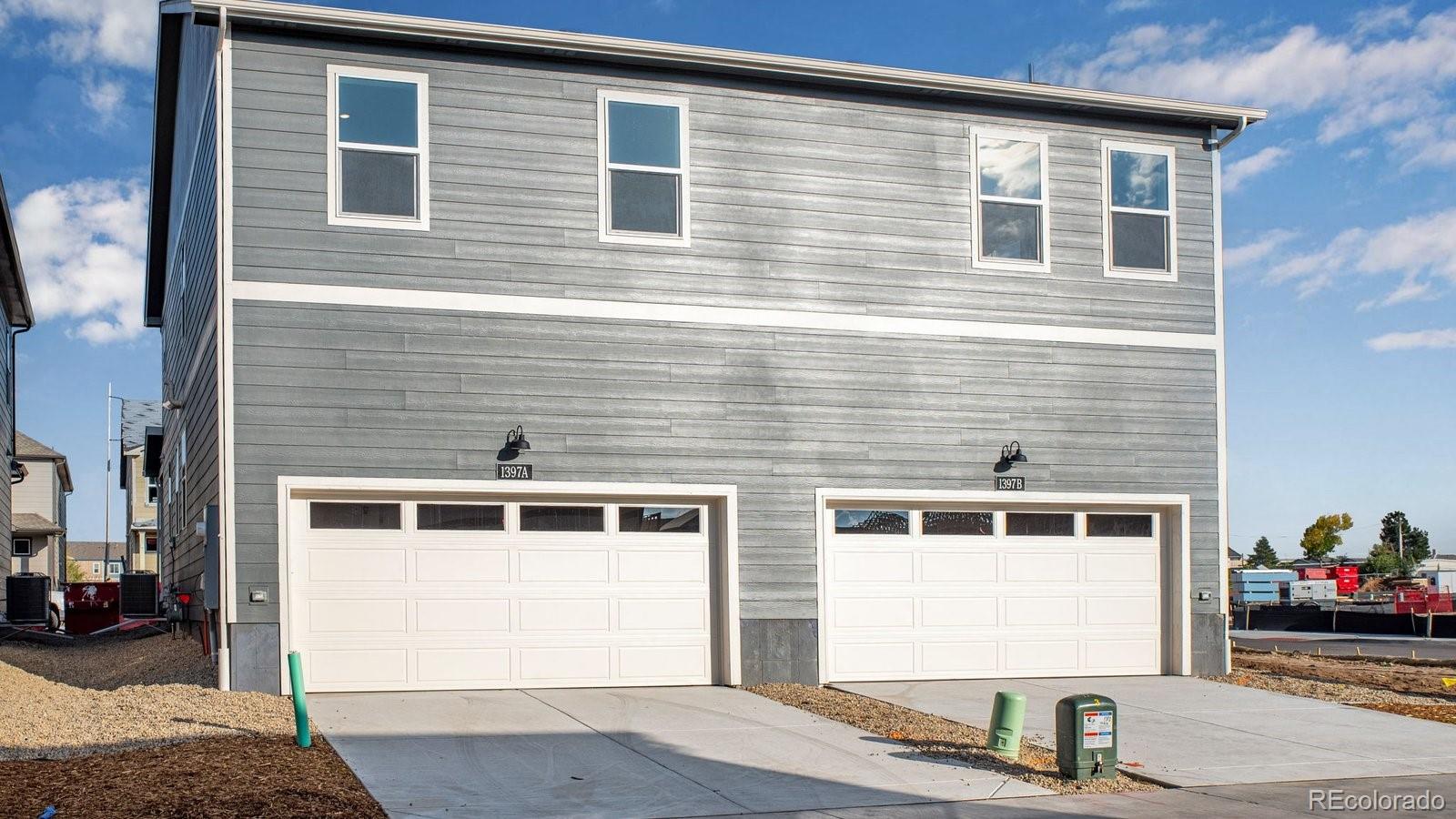 1349 South Chester Street, Unit A Denver, CO 80247 - Photo 13 of 15 a front view of a house with parking