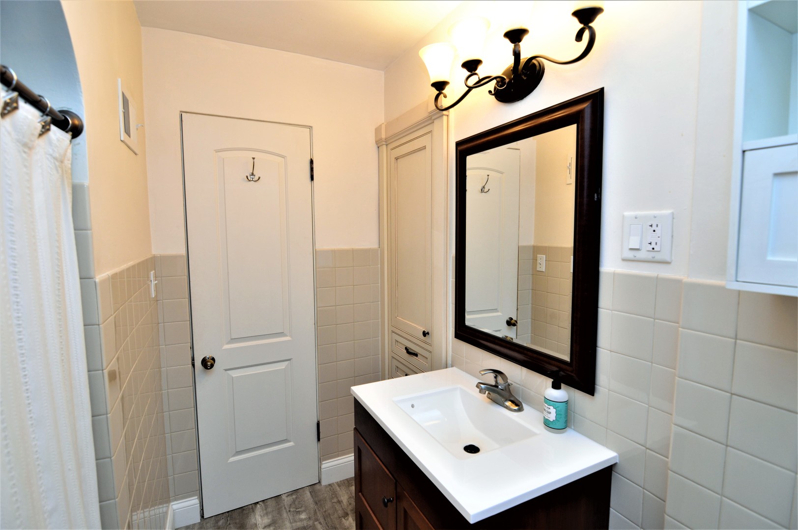 518 North Reed Street Joliet, IL 60435 - Photo 14 of 18 a bathroom with a sink a mirror and a shower