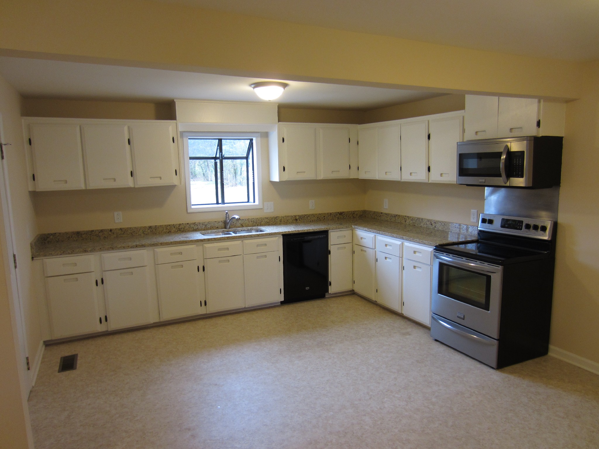 670 Vesta Road Lebanon, TN 37090 - Photo 9 of 20 a kitchen with granite countertop white cabinets and stainless steel appliances