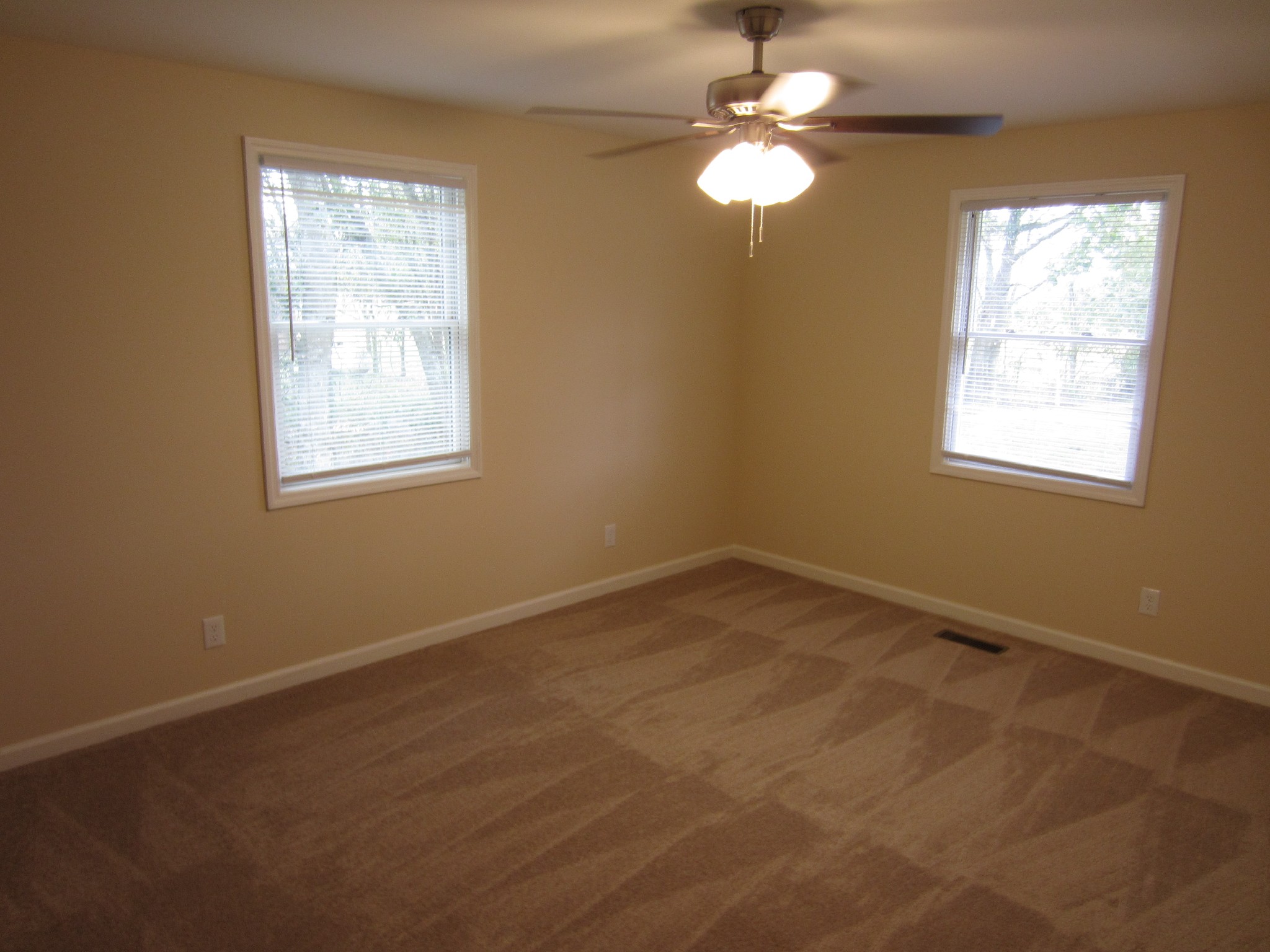 670 Vesta Road Lebanon, TN 37090 - Photo 10 of 20 an empty room with windows and chandelier fan