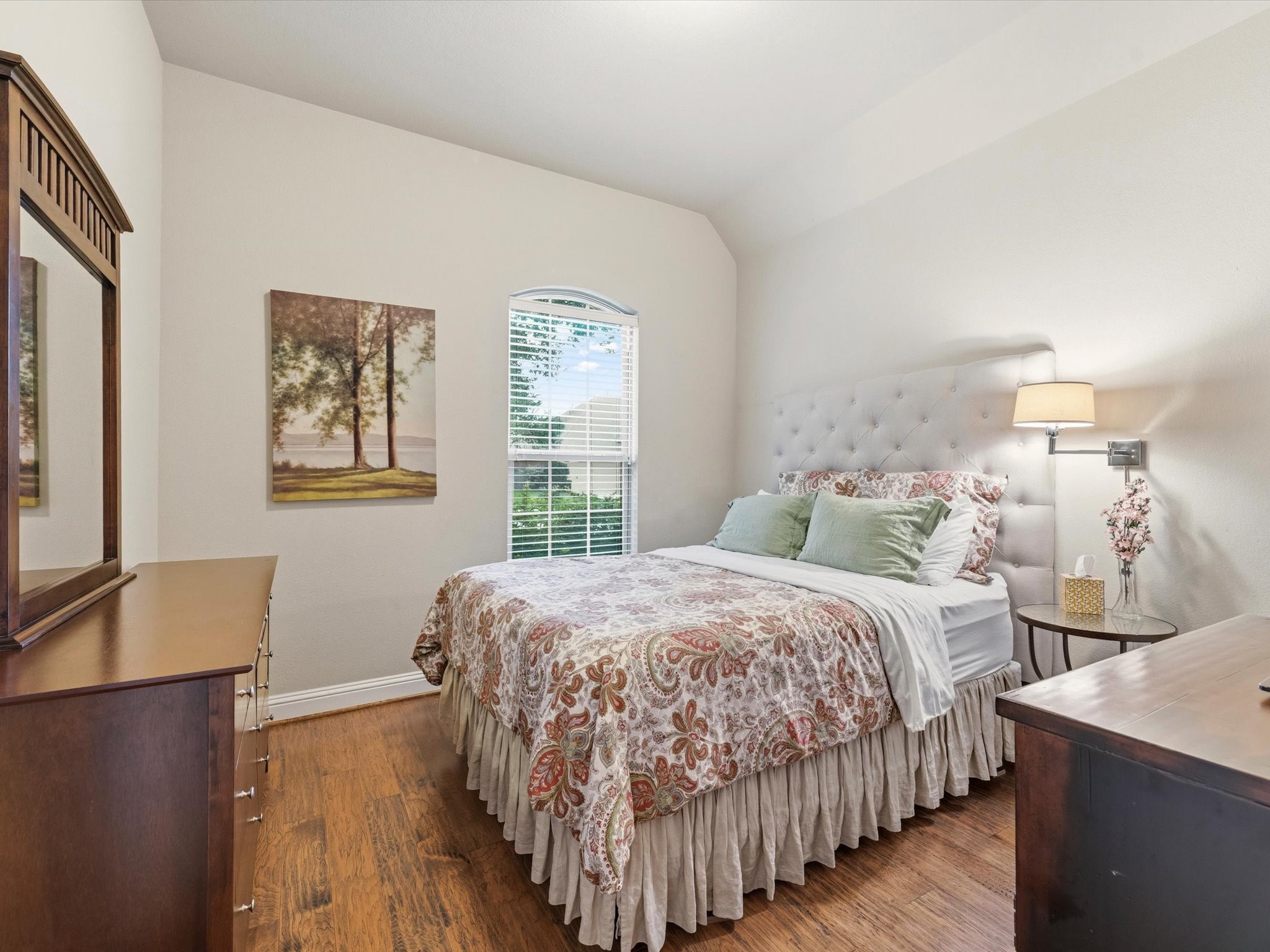 3907 Randle Ridge Court Fulshear, TX 77441 - Photo 22 of 46 This first-floor front left side bedroom features warm wood flooring, walk in closet and can accommodate a queen-sized bedroom set. A large window provides natural light, and the view of the west facing front yard.