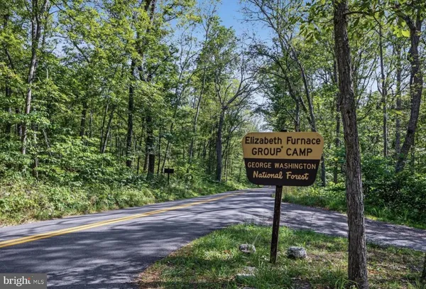 a sign on the side of the tree