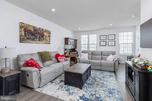 a living room with furniture flat screen tv and a couch