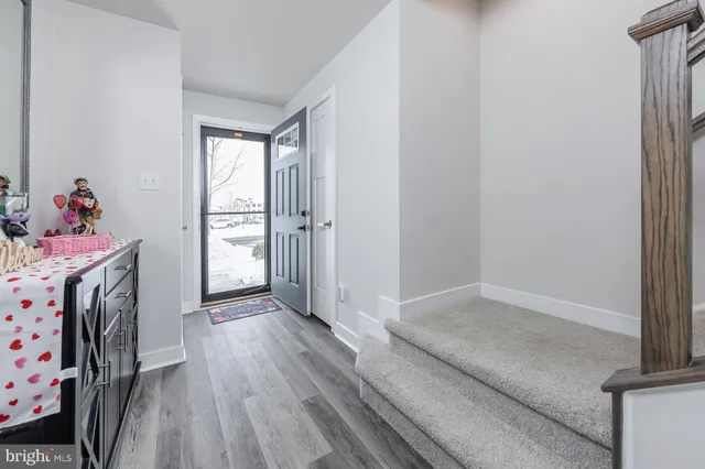 a view of a livingroom with wooden floor and a window