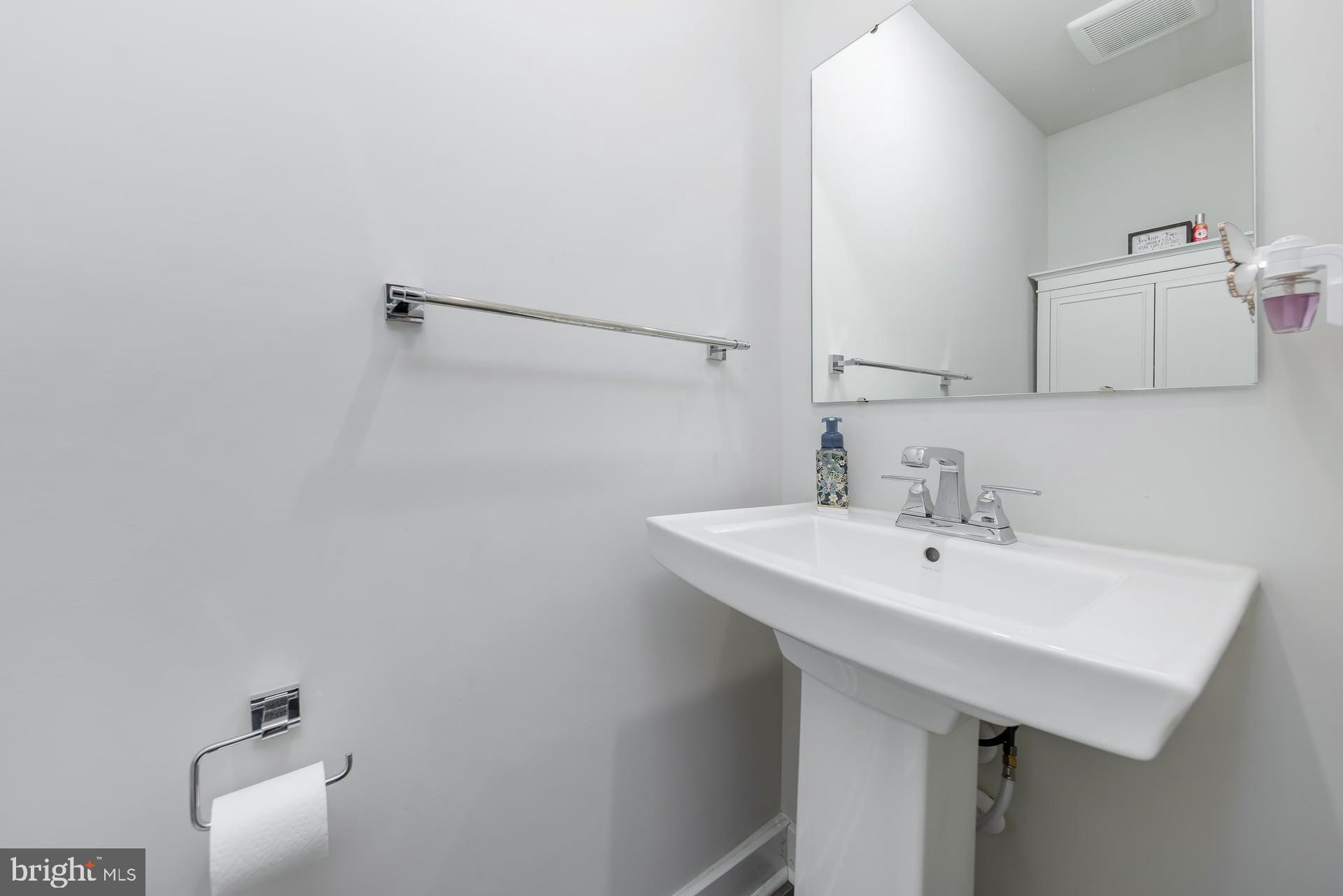 246 Freedom Way Sicklerville, NJ 08081 - Photo 5 of 23 a bathroom with a sink and a mirror