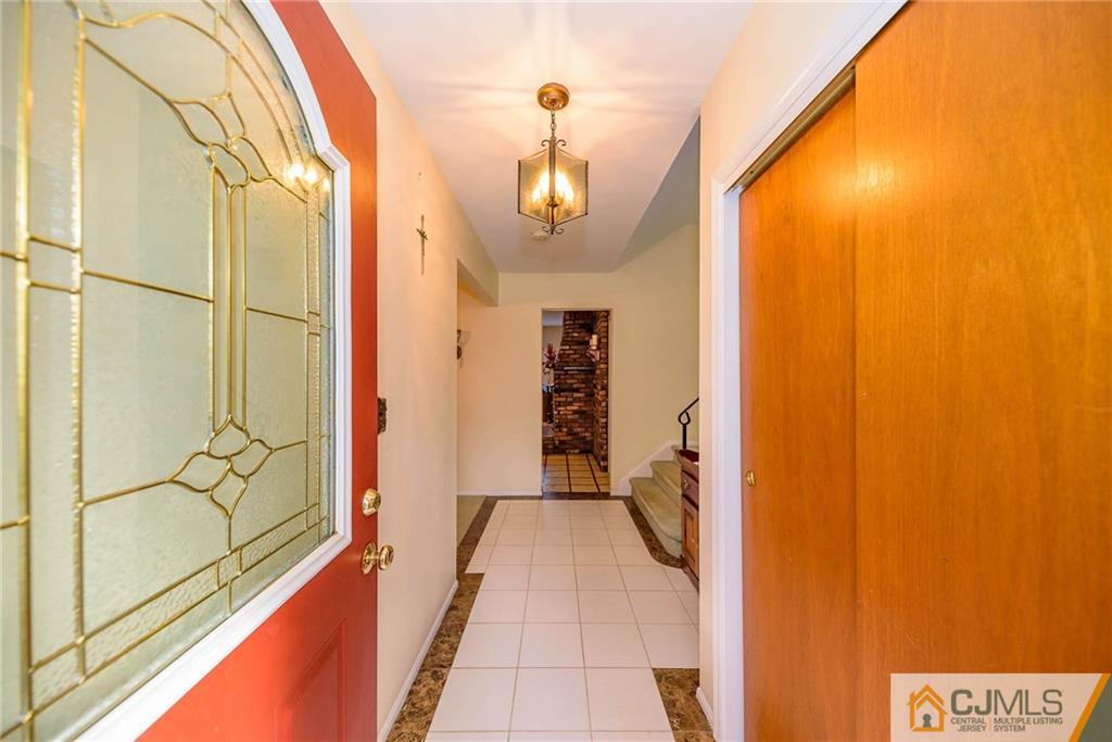 857 Hermann Road North Brunswick, NJ 08902 - Photo 2 of 25 a view of a hallway with wooden shelves