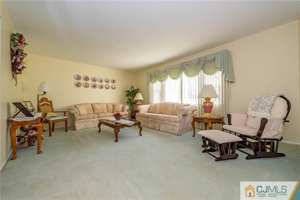 857 Hermann Road North Brunswick, NJ 08902 - Photo 11 of 25 a living room with furniture and a large window