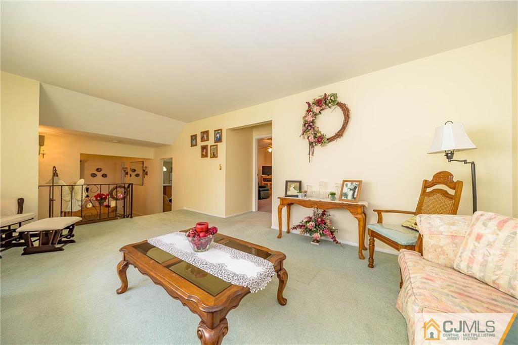 857 Hermann Road North Brunswick, NJ 08902 - Photo 12 of 25 a living room with furniture a air conditioner and a table