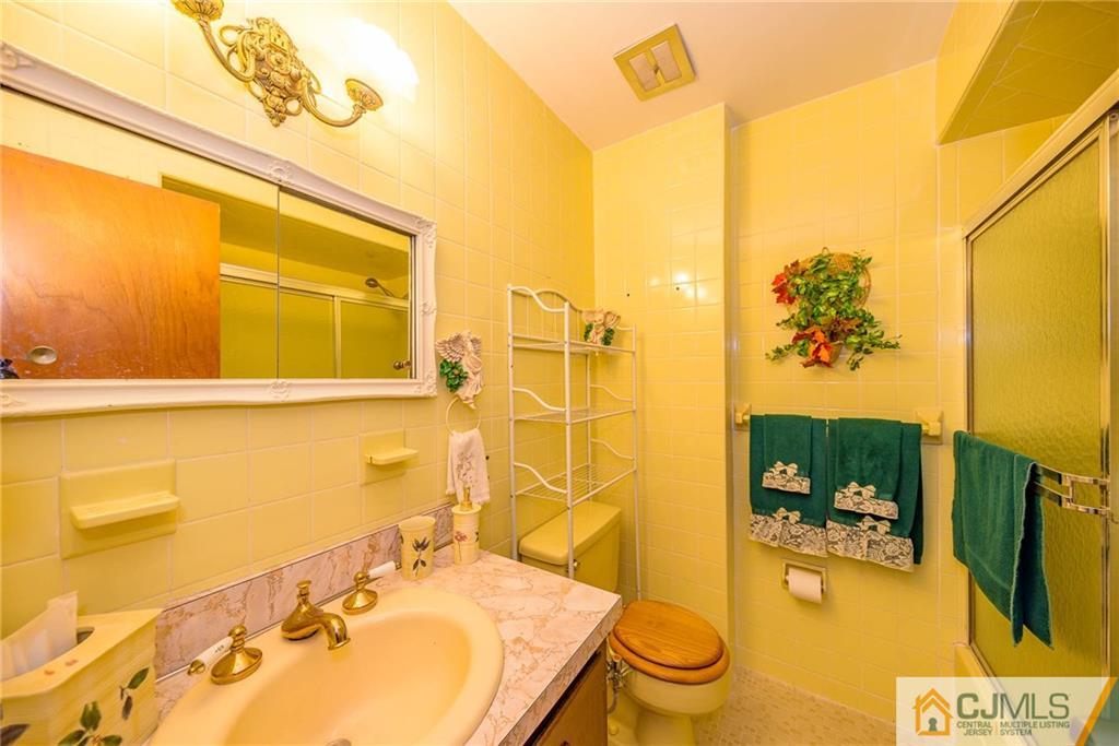 857 Hermann Road North Brunswick, NJ 08902 - Photo 15 of 25 a bathroom with a sink and mirror