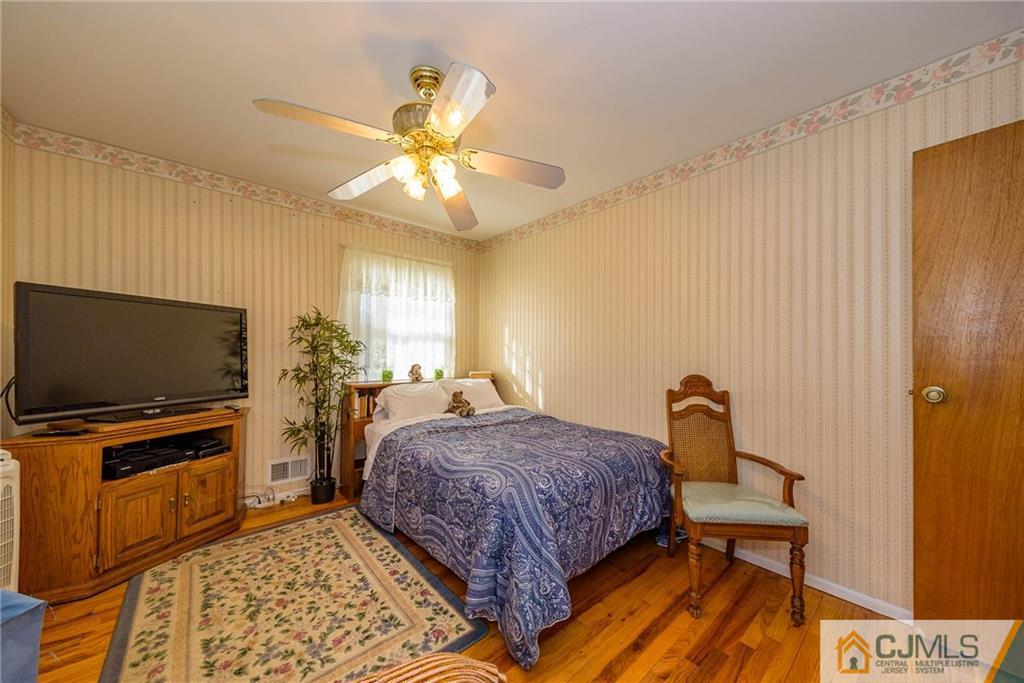 857 Hermann Road North Brunswick, NJ 08902 - Photo 17 of 25 a bedroom with a bed and a flat screen tv