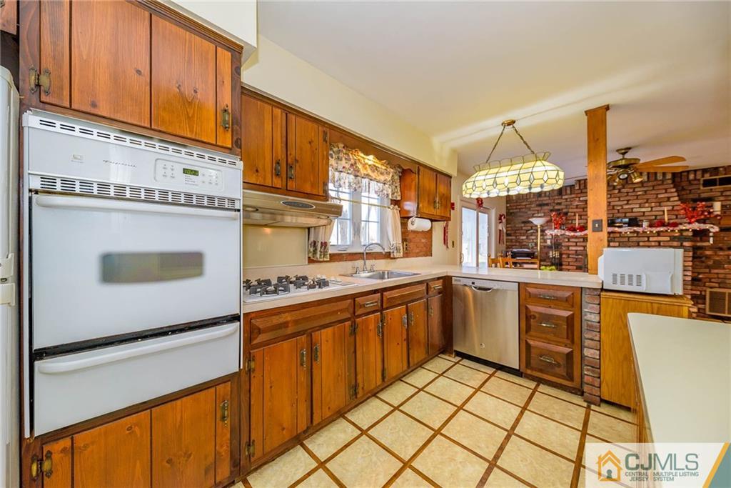 857 Hermann Road North Brunswick, NJ 08902 - Photo 5 of 25 a kitchen with stainless steel appliances granite countertop a sink and cabinets