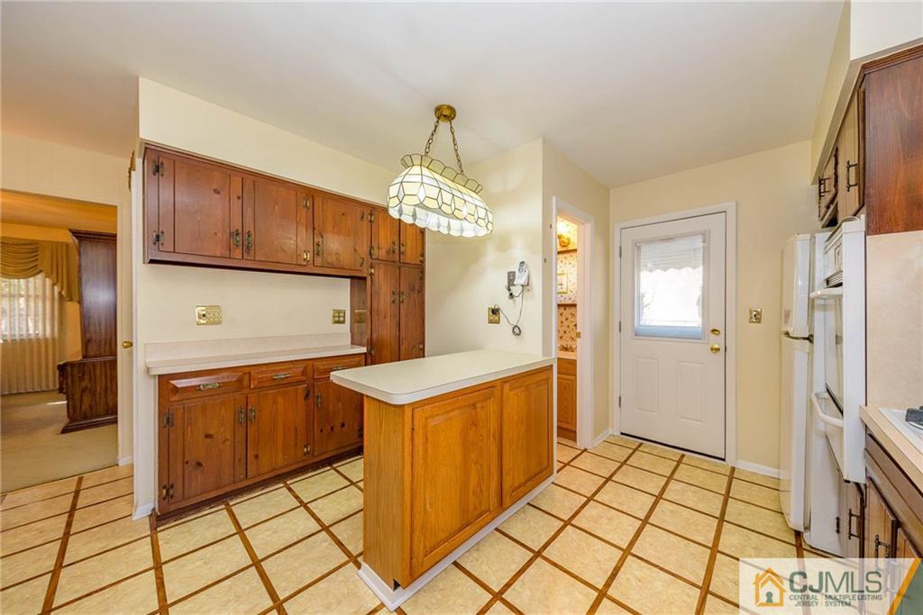 857 Hermann Road North Brunswick, NJ 08902 - Photo 6 of 25 a kitchen with stainless steel appliances a refrigerator and a stove top oven