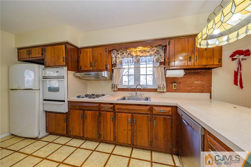 857 Hermann Road North Brunswick, NJ 08902 - Photo 7 of 25 a kitchen with stainless steel appliances granite countertop a refrigerator and a sink