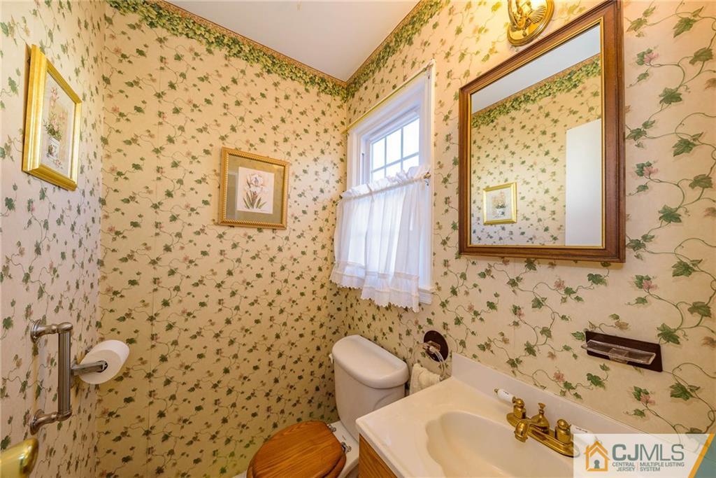 857 Hermann Road North Brunswick, NJ 08902 - Photo 10 of 25 a bathroom with a sink and a mirror