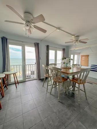 a view of a dining room with furniture and a large window