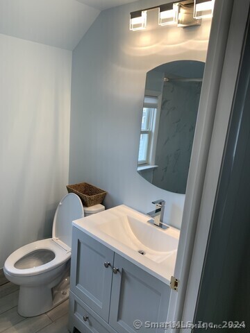 Undisclosed Address Fairfield, CT 06824 - Photo 18 of 23 a bathroom with a toilet sink and mirror