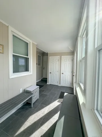 a spacious bedroom with a bed and wooden floor