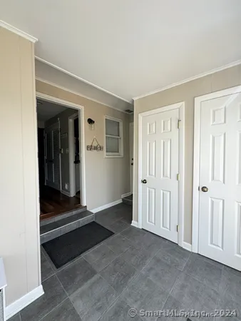 a view of a livingroom with wooden floor and closet area