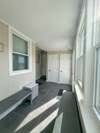 a spacious bedroom with a bed and wooden floor