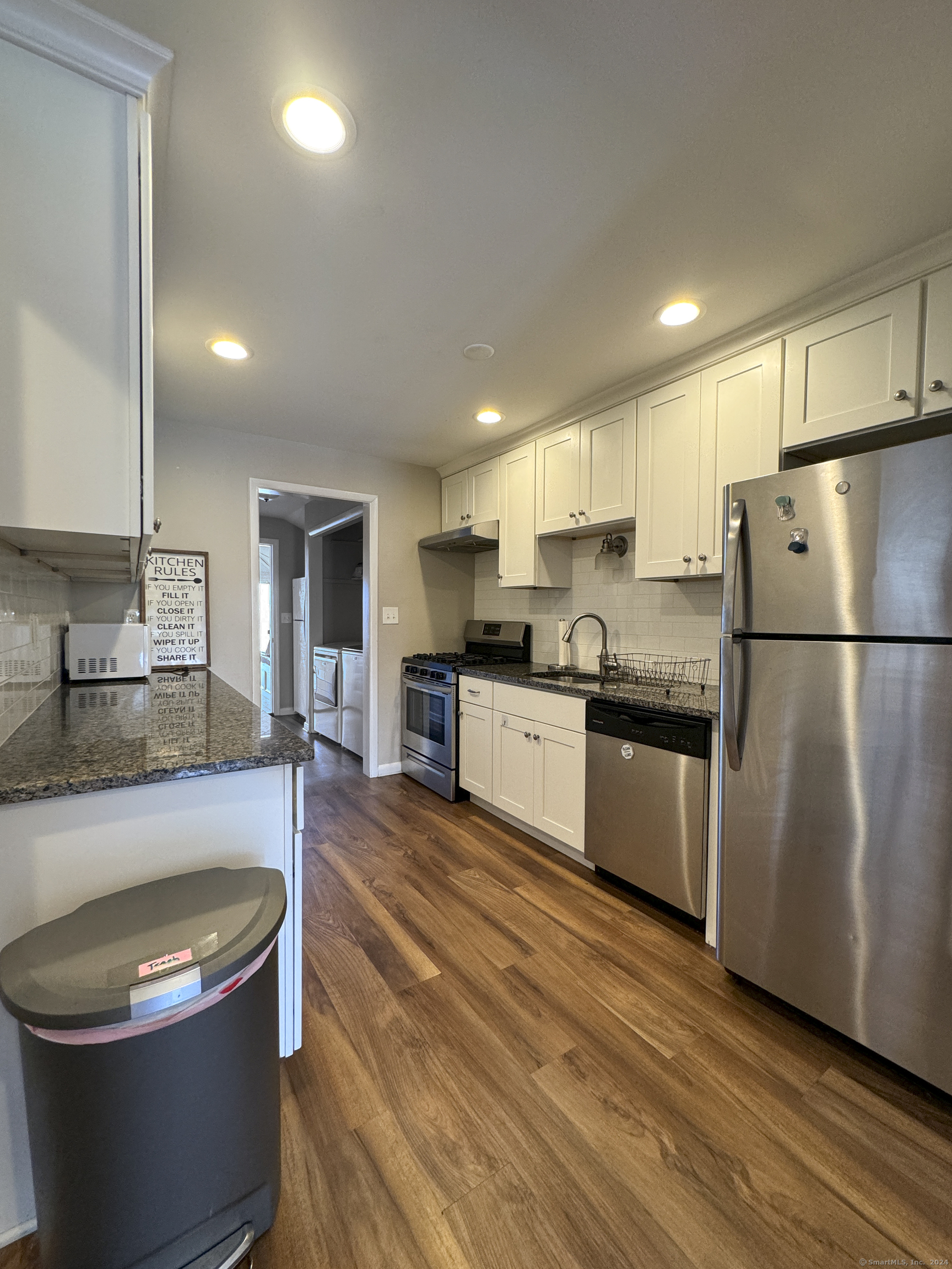 Undisclosed Address Fairfield, CT 06824 - Photo 8 of 23 a large kitchen with stainless steel appliances granite countertop a sink a stove a refrigerator a center island and a stove