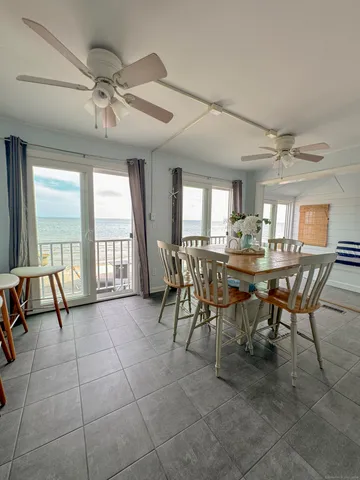 a view of a dining room with furniture and a large window