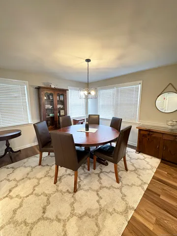 a view of a dining room with a table and chairs