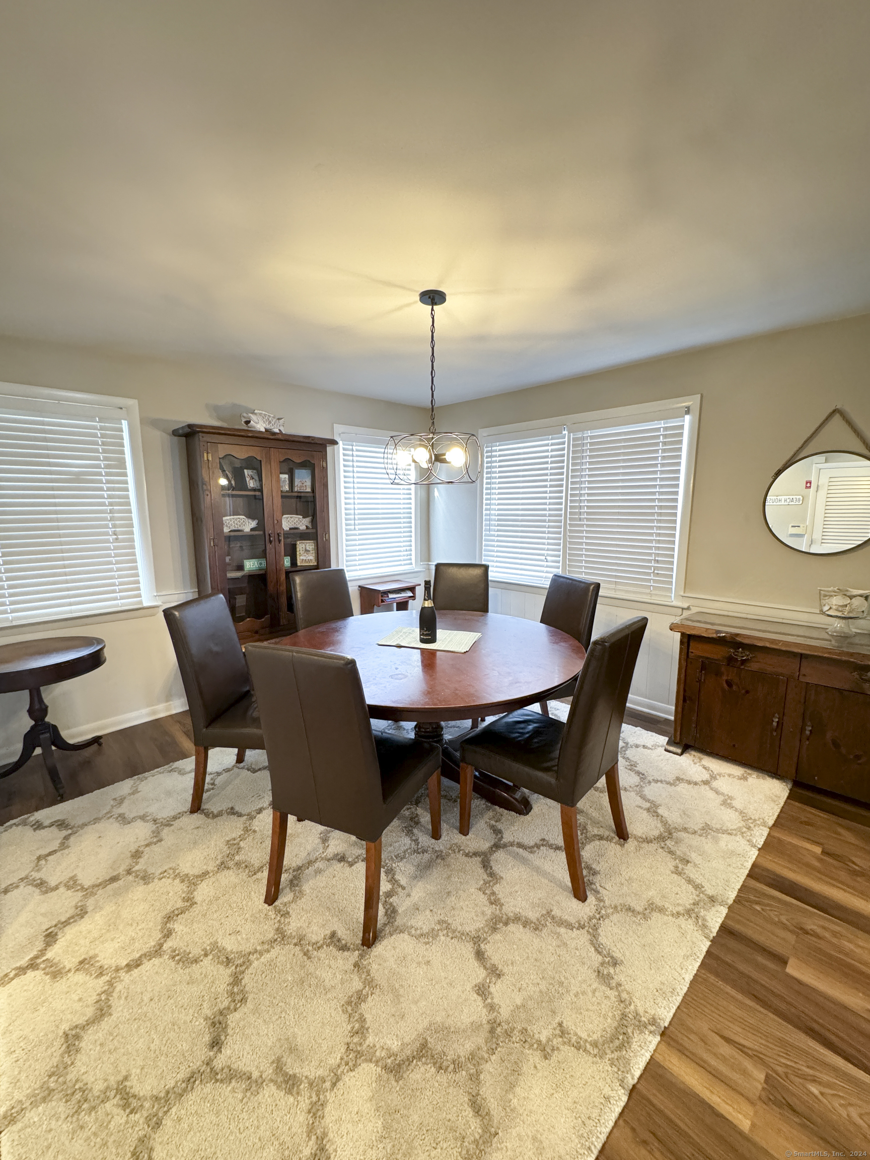 Undisclosed Address Fairfield, CT 06824 - Photo 10 of 23 a view of a dining room with a table and chairs