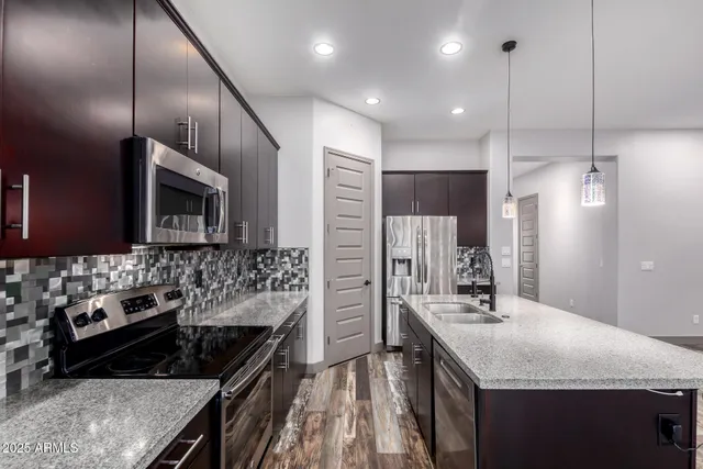 a kitchen with a sink stove and refrigerator