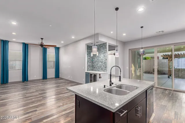 a kitchen with kitchen island a sink and a stove
