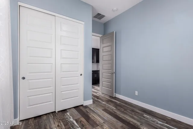 a view of walk in closet with empty racks