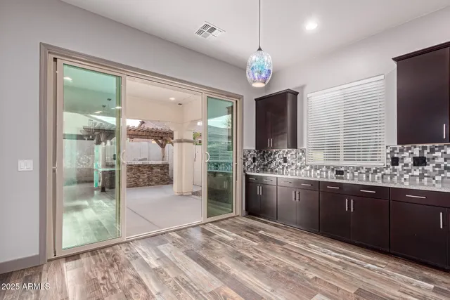 a large bathroom with a granite countertop sink a large mirror and a shower