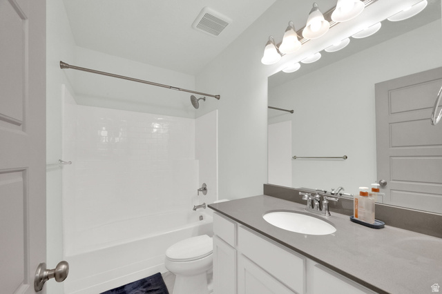 6120 North Sheps Ridge Road Eagle Mountain, UT 84005 - Photo 14 of 43 Bathroom featuring a vanity with an integrated sink, a gray countertop, and white cabinetry