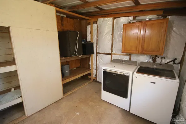 a view of an empty room with a fireplace and a window
